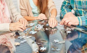 Working a puzzle while receiving Alzheimer's care Tuscaloosa